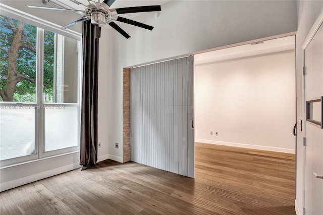 unfurnished room with ceiling fan and hardwood / wood-style flooring