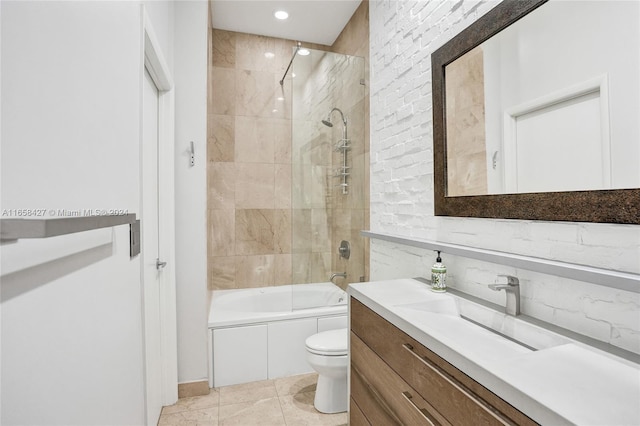 full bathroom with vanity, backsplash, toilet, tile patterned floors, and tiled shower / bath combo