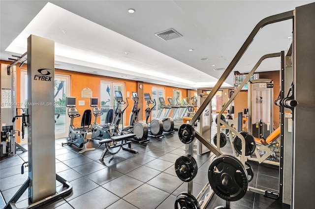 gym with a raised ceiling