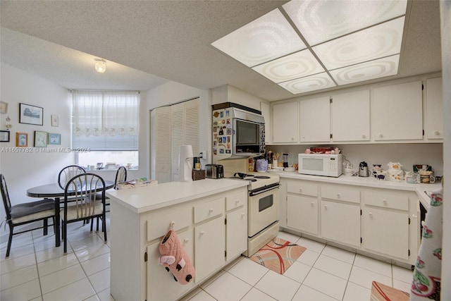 kitchen with white cabinets, light tile patterned flooring, kitchen peninsula, white appliances, and a textured ceiling