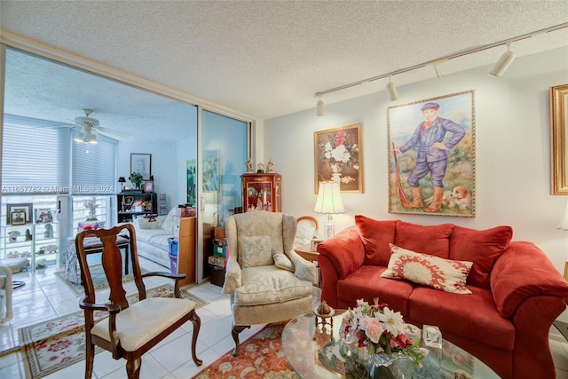 living room featuring ceiling fan, expansive windows, and a textured ceiling