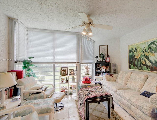 tiled living room with ceiling fan and a textured ceiling