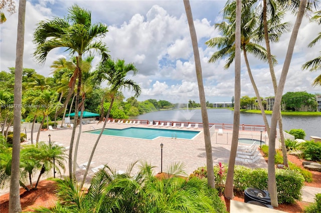 view of swimming pool featuring a water view