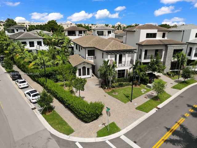 view of front of home featuring a balcony and a front yard