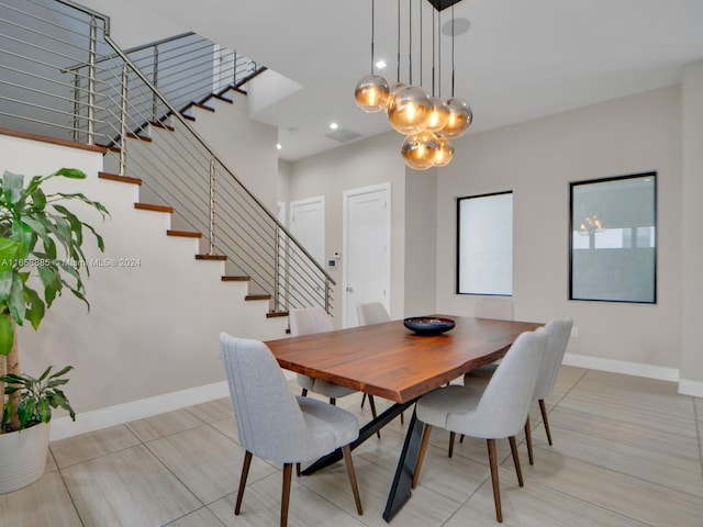 dining space featuring an inviting chandelier and light tile patterned flooring