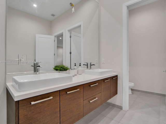 bathroom with tile patterned floors, vanity, and toilet