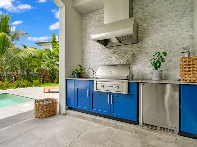 exterior space featuring exterior kitchen, a grill, and sink