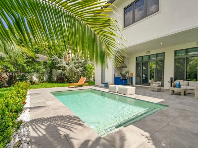 view of pool with a patio and an outdoor living space