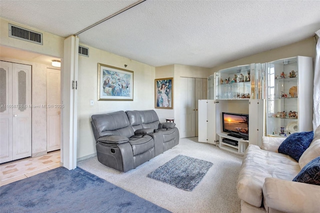 living room with a fireplace, light carpet, and a textured ceiling