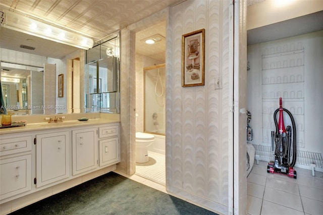 full bathroom with tile patterned floors, visible vents, vanity, and enclosed tub / shower combo