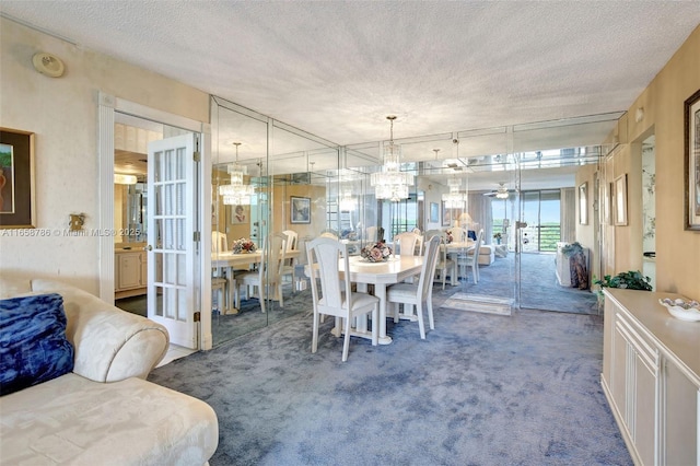 carpeted dining area with a textured ceiling and an inviting chandelier