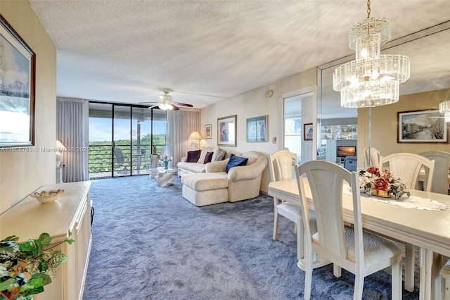 dining area with floor to ceiling windows, ceiling fan with notable chandelier, a textured ceiling, and carpet