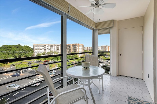 balcony featuring a city view and ceiling fan