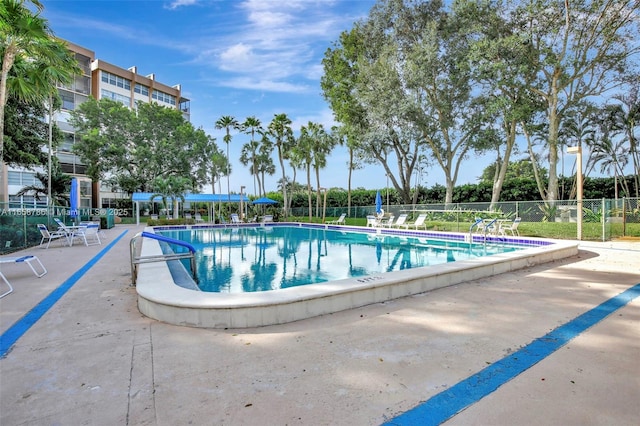 community pool featuring a patio and fence