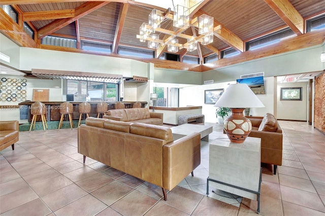 living area featuring tile patterned floors, beamed ceiling, wood ceiling, and a high ceiling