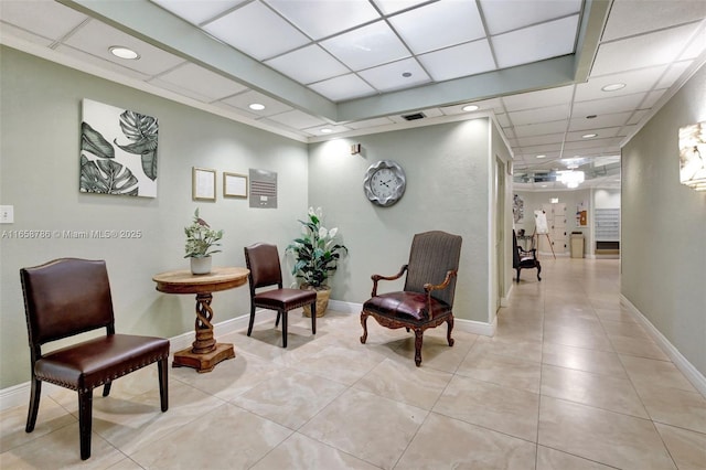 sitting room featuring light tile patterned flooring, visible vents, and baseboards