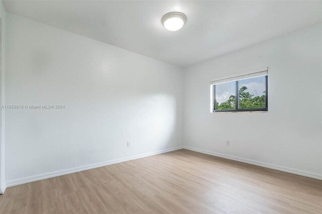 spare room with light wood-type flooring