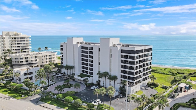 bird's eye view with a water view and a beach view