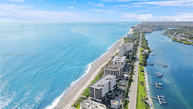 bird's eye view featuring a water view and a beach view