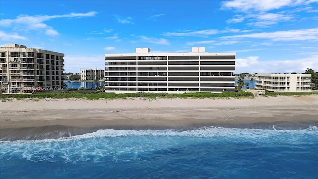 view of swimming pool with a view of the beach and a water view