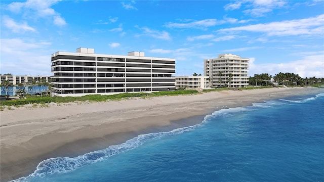 bird's eye view with a water view and a beach view