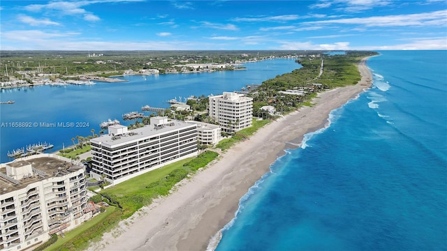 birds eye view of property with a view of the beach and a water view