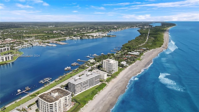 drone / aerial view featuring a water view and a view of the beach