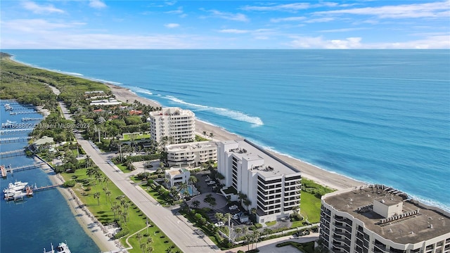 drone / aerial view featuring a view of the beach and a water view