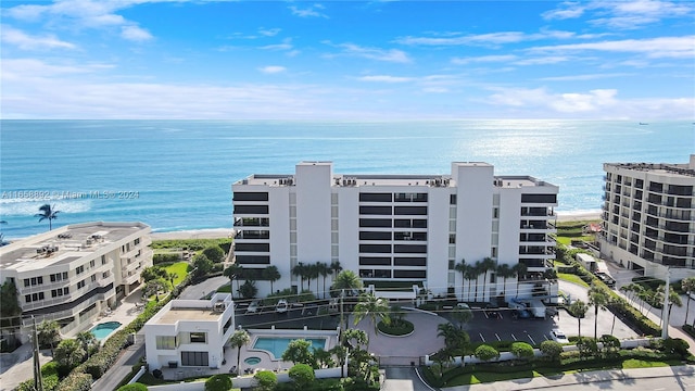 view of property featuring a community pool and a water view