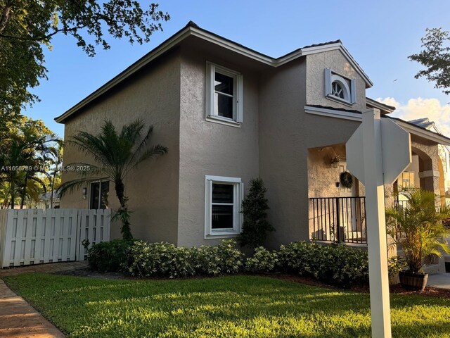 view of side of home with a yard