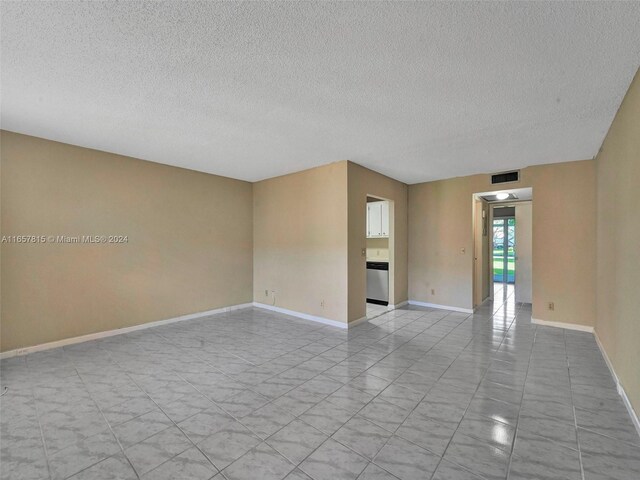 empty room featuring a textured ceiling