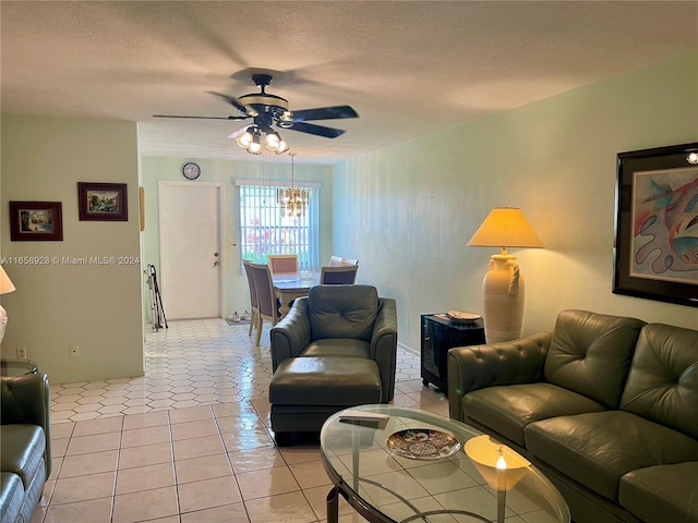 living room featuring a textured ceiling, light tile patterned flooring, and ceiling fan