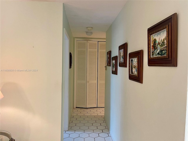 hallway with tile patterned flooring