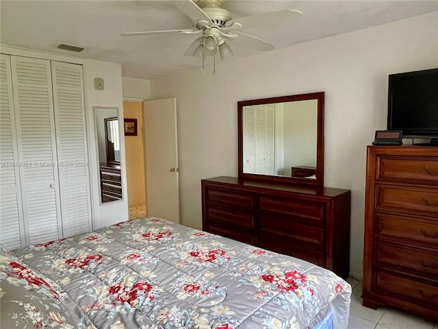 tiled bedroom with ceiling fan and a closet