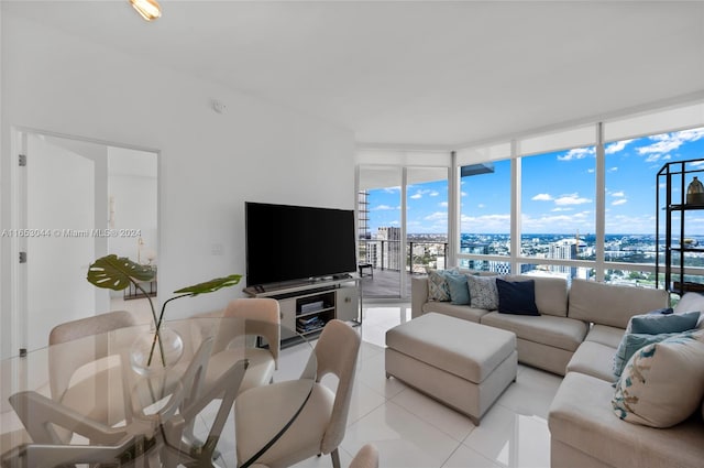 tiled living room featuring floor to ceiling windows