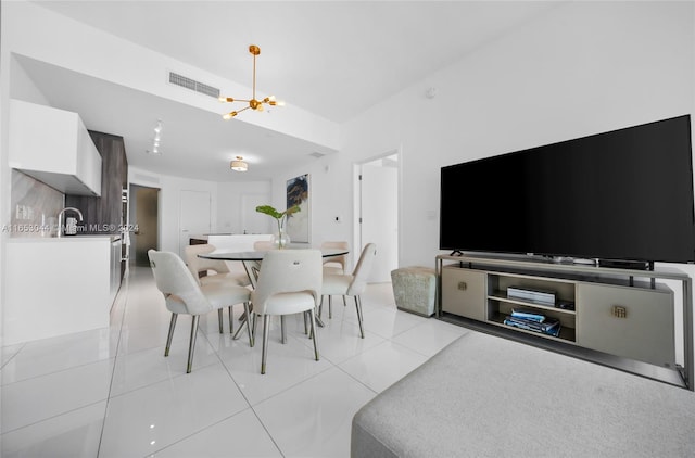 dining room featuring an inviting chandelier and light tile patterned floors