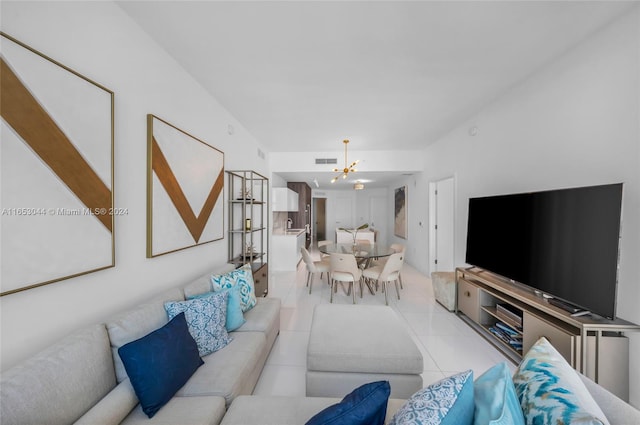 living room with a chandelier and light tile patterned floors