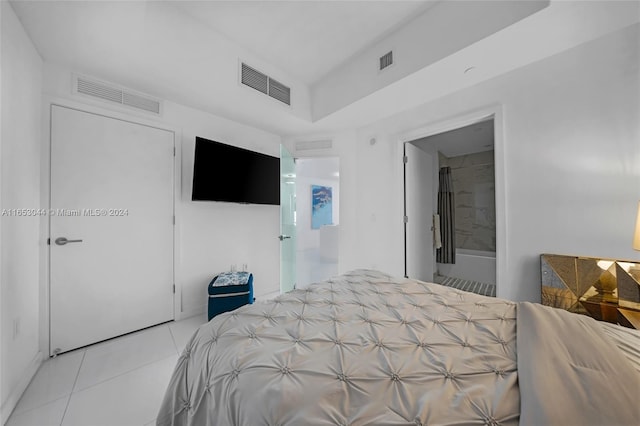 bedroom featuring light tile patterned flooring, a closet, and connected bathroom