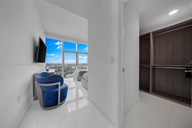 interior space with floor to ceiling windows and light tile patterned floors