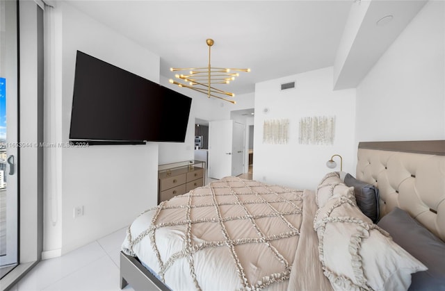 bedroom featuring light tile patterned floors and a notable chandelier