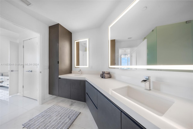 bathroom featuring tile patterned flooring and vanity