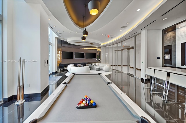 recreation room featuring a tray ceiling and pool table