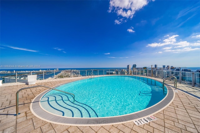 view of swimming pool with a water view