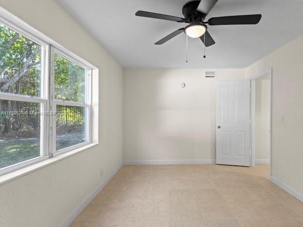 empty room with plenty of natural light and ceiling fan