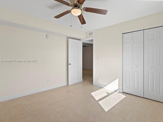 unfurnished bedroom featuring a closet and ceiling fan