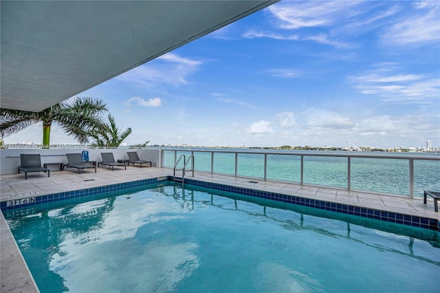 view of pool with a water view