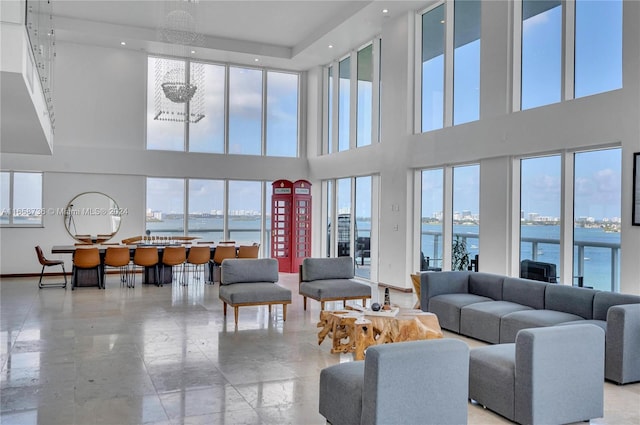 7939 E Dr Unit 15, North Bay Village, FL 33141 - living room featuring a towering ceiling and a water view