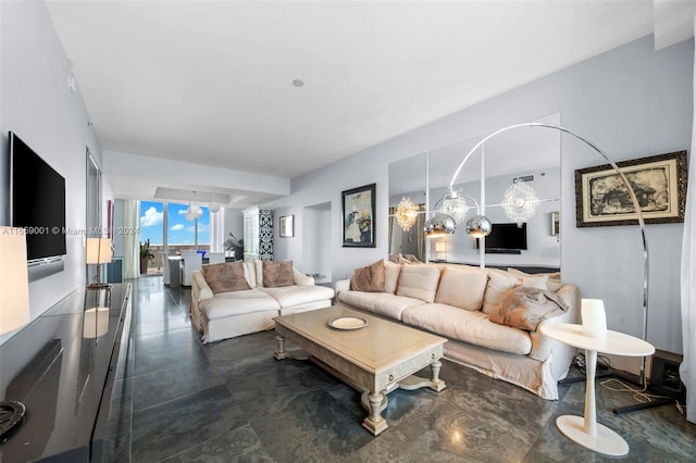 living room featuring an inviting chandelier and a wall of windows