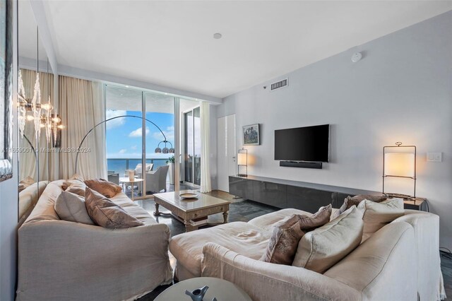 living room with expansive windows and an inviting chandelier