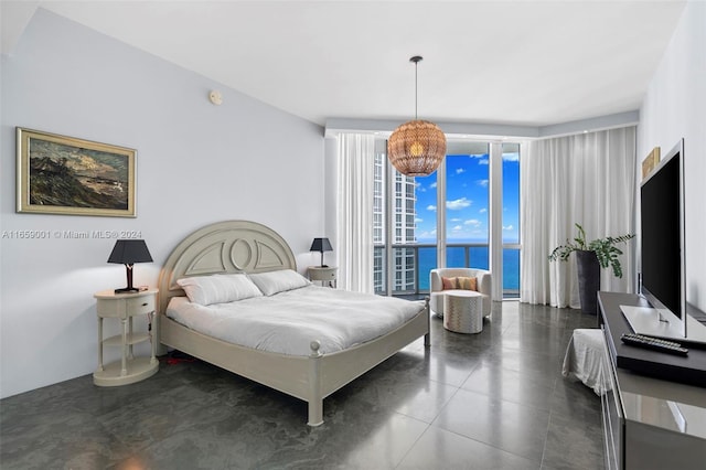 bedroom featuring access to exterior, floor to ceiling windows, and an inviting chandelier